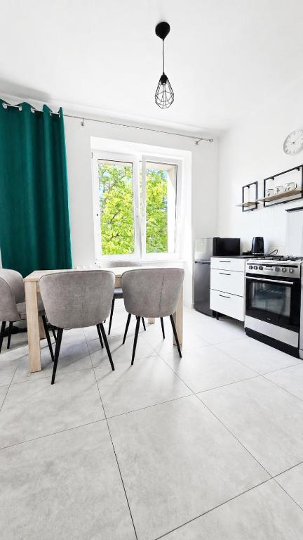 a kitchen with a table and chairs in a room at Apartament BIELSKA 26 in Płock