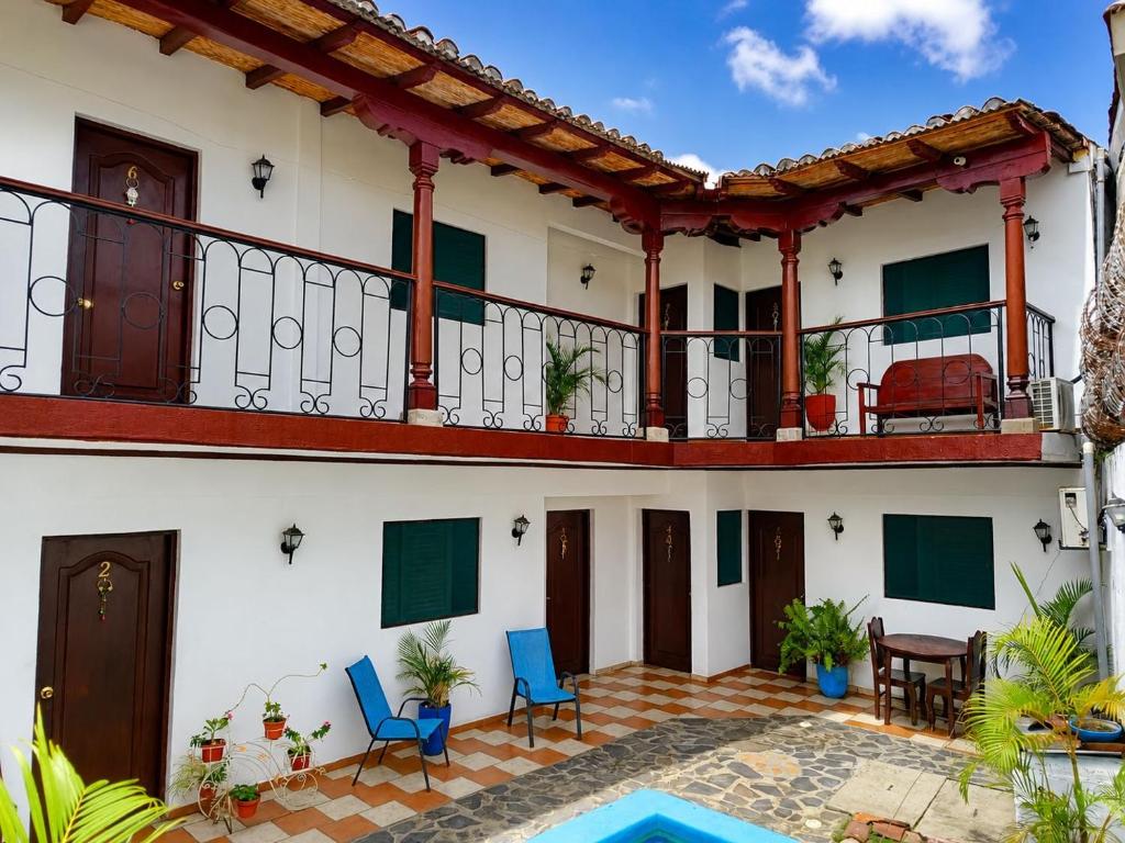 a house with a balcony and a patio at Hotel Valeria in Granada