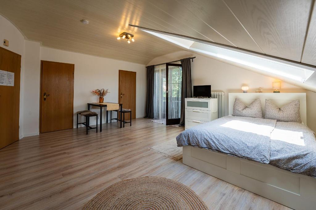 a large bedroom with a bed and a skylight at Ferienwohnung Kampenwand in Bad Endorf