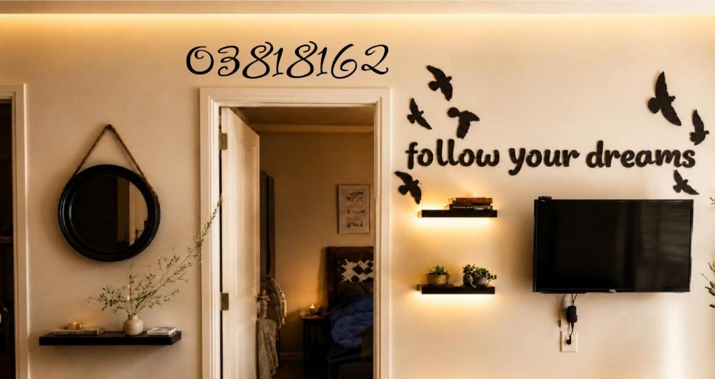 a living room with a tv and bats on the wall at chalet in saint remon in Al Bāţiyah