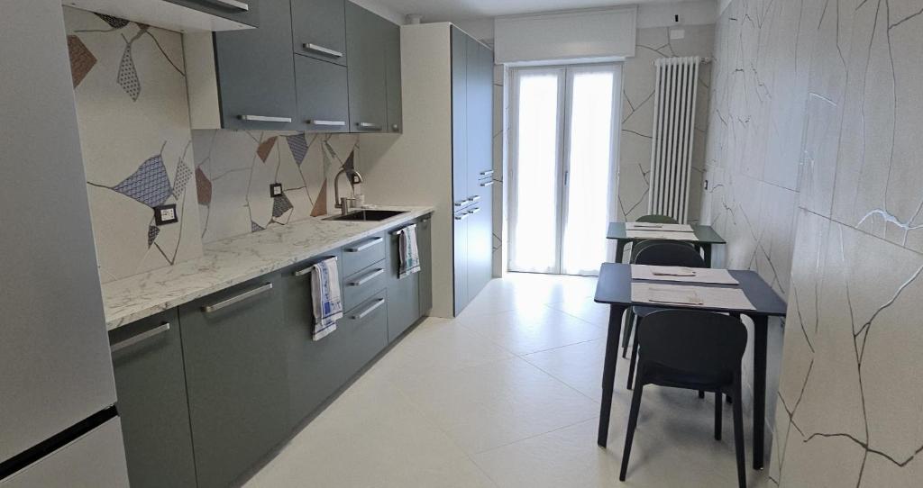 a kitchen with a counter and a table in it at Drago 48 in Oltre il Colle