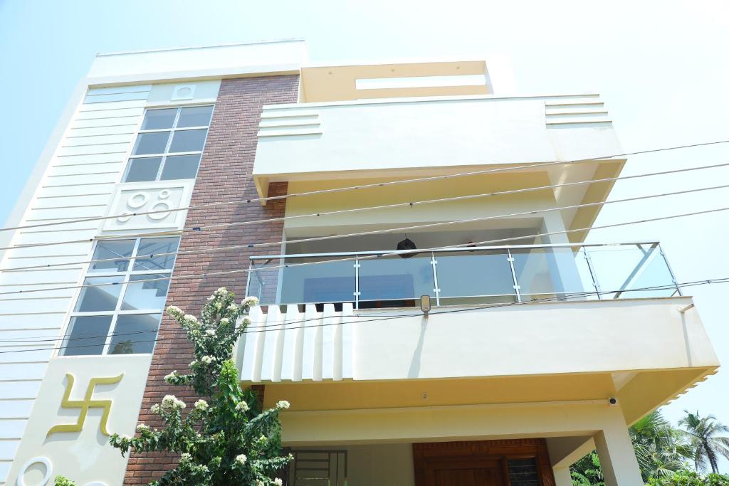 a house with a balcony in front of it at NJ Grand Villa in Kālapettai