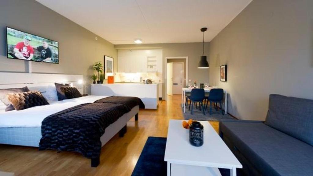 a hotel room with two beds and a couch at Apartment in Skarholmen Stockholm 206 in Stockholm