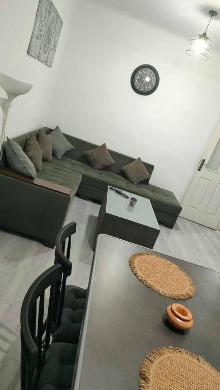 a living room with a couch and a table at Mostaganem sablette in Les Sablettes Mazagran-Plage
