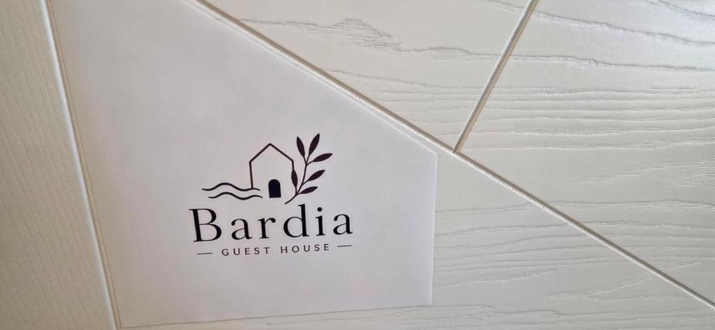 a sign on the wall of a guest house at Bardia Guest House in Dorgali