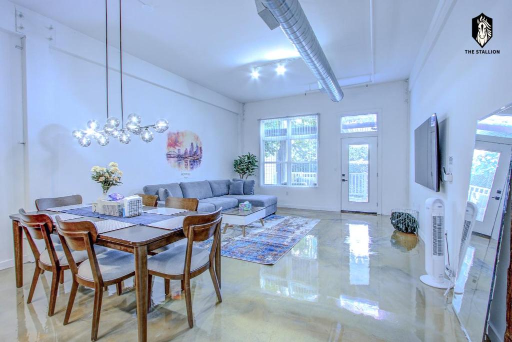 a living room with a table and a couch at The Stallion #101 - 1BD Modern Loft with Private Patio - Walk to various attractions in Memphis