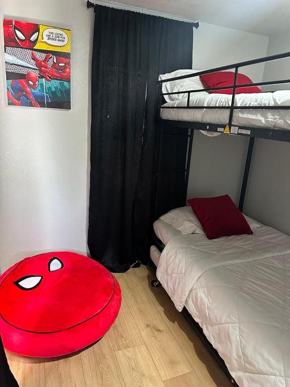 a bedroom with a red oar sitting on the floor at Superhero Family Home Near Downtown Amarillo in Amarillo