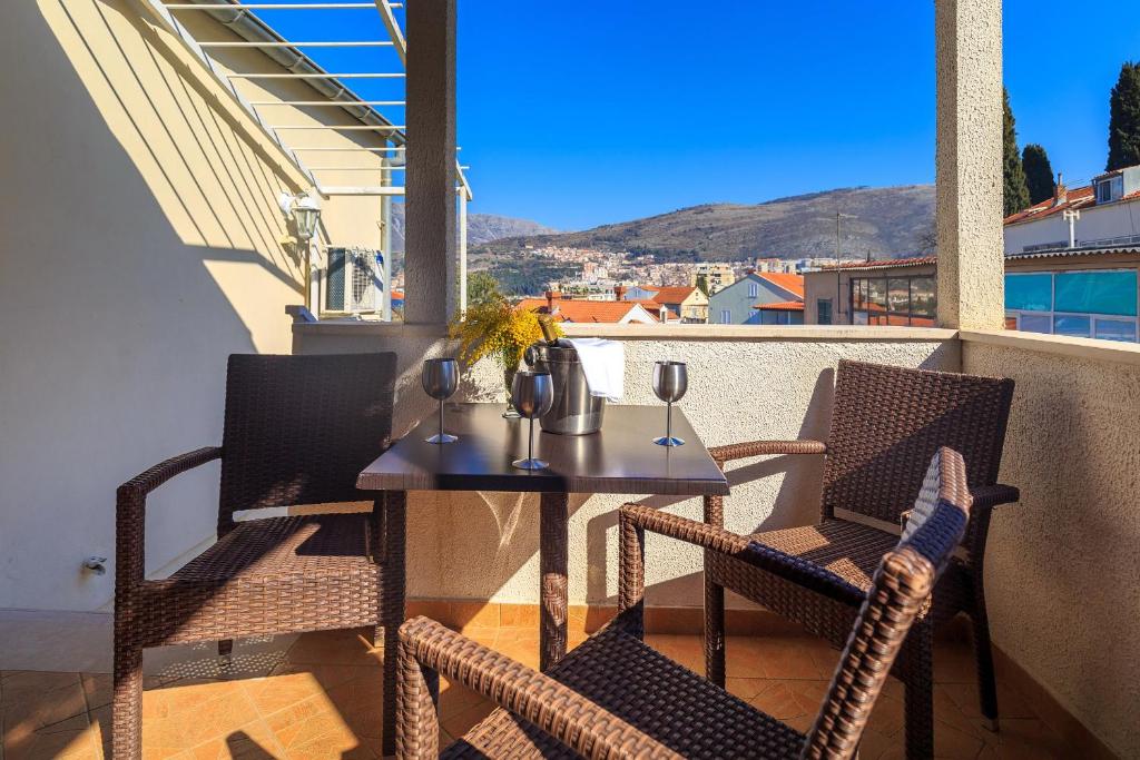a table and chairs on a balcony with a view at Apartment Luki Dubrovnik in Dubrovnik