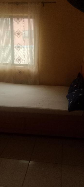 a window in a room with a mattress in front of it at Elegance hotel in Ijaiye