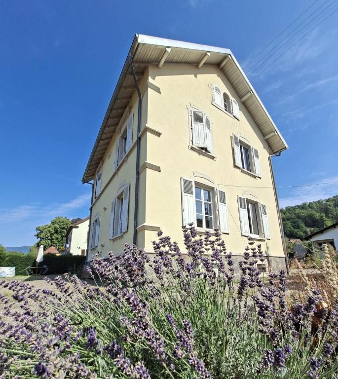a building with purple flowers in front of it at Villa Amarinis in Saint-Amarin