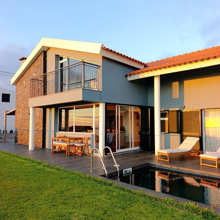 a house with a pool in front of it at Sunset Cottage - Special Places in Ponta do Pargo