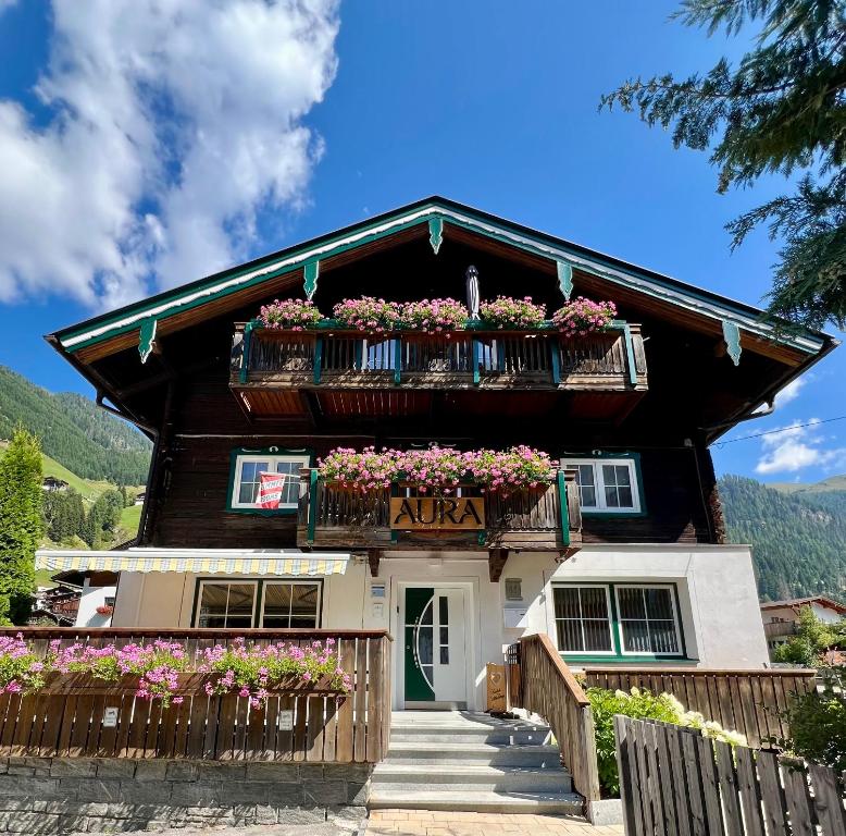 a house with flower boxes on the front of it at AURA Bed & Breakfast in Sankt Jakob in Defereggen