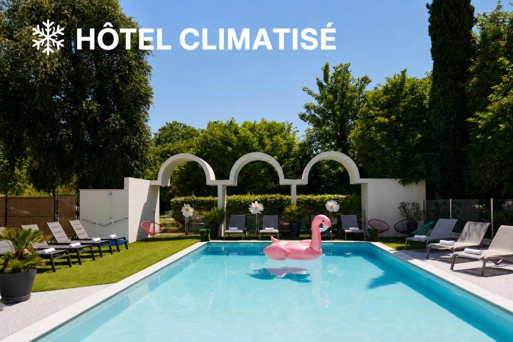 a swimming pool with a pink swan in the water at Ibis Styles Cognac in Châteaubernard