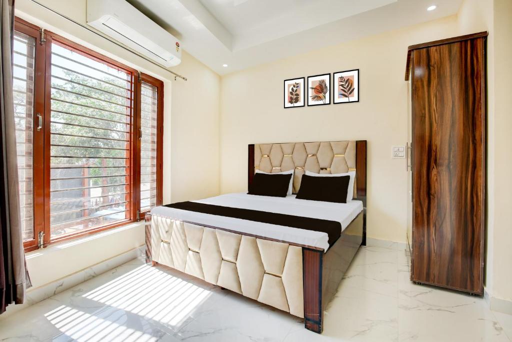 a bedroom with a bed and a window at Hotel O Classic in in Kharar