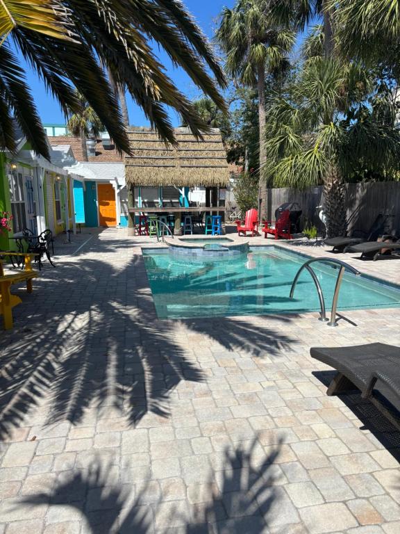 a shadow of palm trees and a swimming pool at Seaside Retreat Cottages #3 in Clearwater Beach