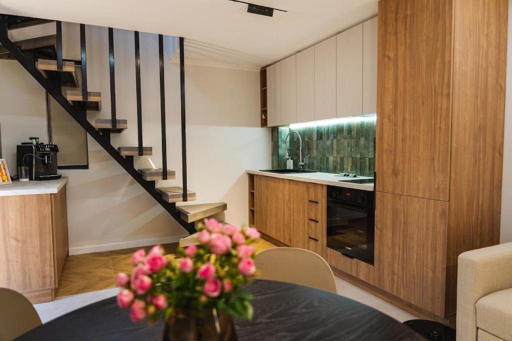 a kitchen with a table with a vase of flowers at Villa ARTÉ in Shabla