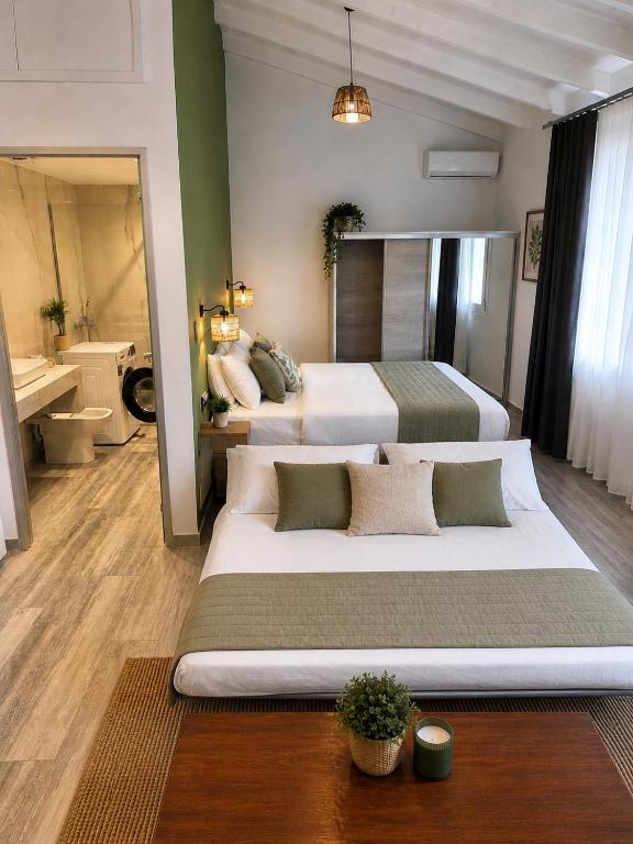 a large bedroom with two beds and a bathroom at Bianco Boutique in Parga