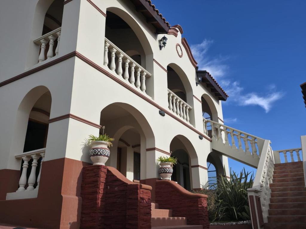 a building with a staircase in front of it at DEL INFINITO in Capilla del Monte