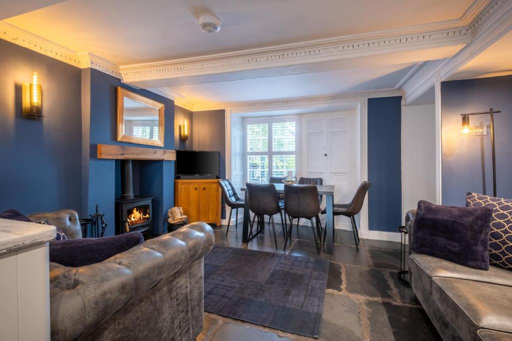 a living room with a couch and a table at Ross Cottage in Hawkshead