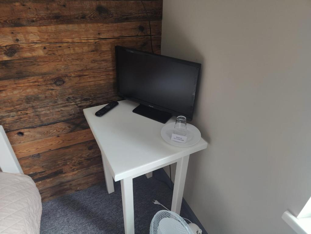 a computer monitor on a white desk in a room at Jaunkemeri in Debeskrogs
