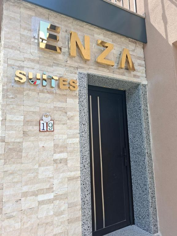 a entrance to a sun tan building with a black door at Enza Suites in Shumen