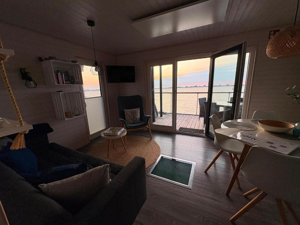 a living room with a view of the ocean at Knobis DreamPlace in Heiligenhafen
