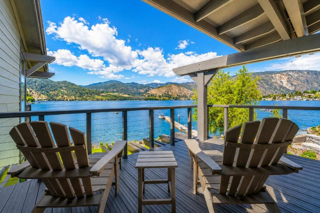 two chairs on a deck with a view of the water at High-end Lakefront Condo B6 Wapato Point Chelan in Manson