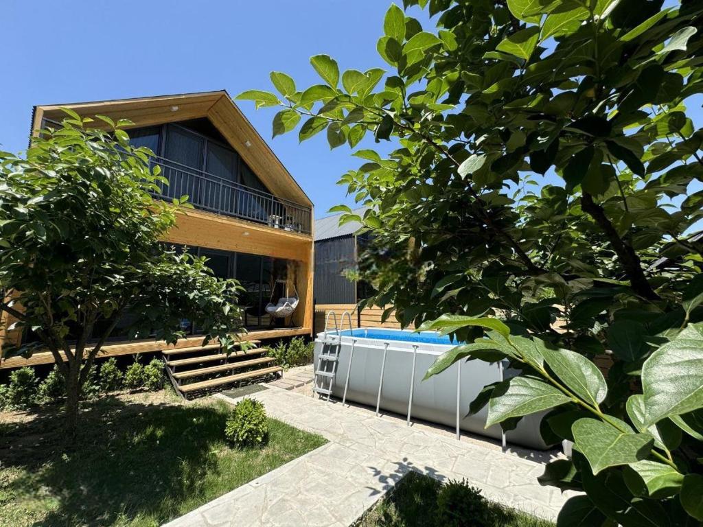 a modern house with a swimming pool and trees at NorWay1 in Ijevan