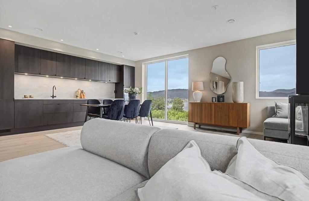 a living room with a couch and a kitchen at Central apartment in quiet area in Ålesund