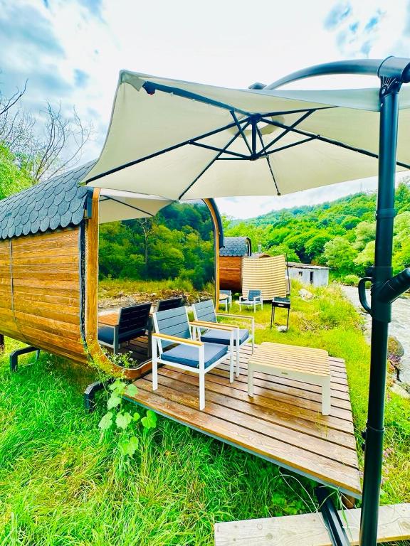 a group of chairs and an umbrella on a deck at Loft Dilijan in Dilijan