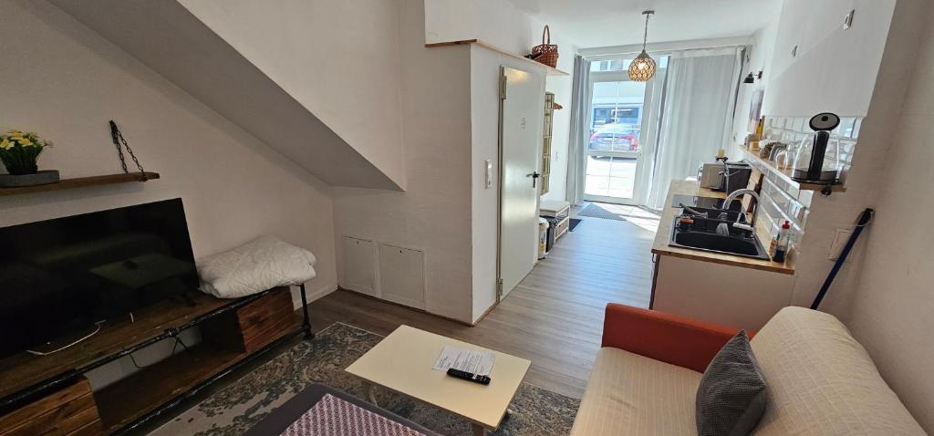a living room with a couch and a tv at Studio "Werkstatt" in Oberndorf in Oberndorf am Neckar