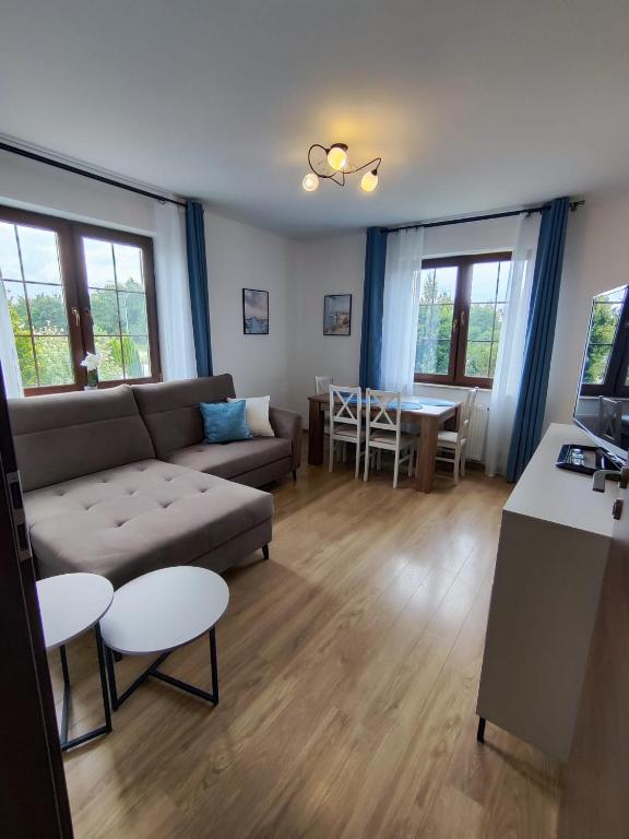 a living room with a couch and a table at Willa Hydrograf - rowery i parking bezpłatnie in Ustka