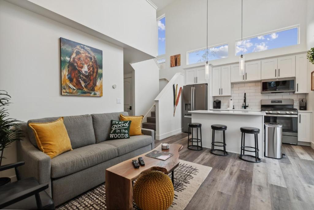 a living room with a couch and a kitchen at Quarry A21 in Whitefish