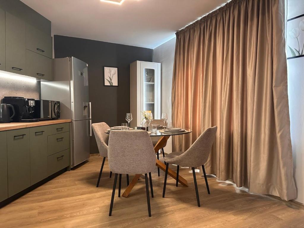 a kitchen and dining room with a table and chairs at Casmere Suite in Pomorie