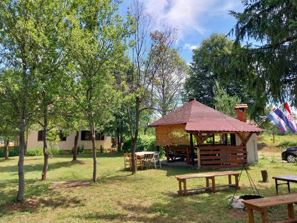 a gazebo and picnic tables in a park at Studioapartment Taiga in Grabovac
