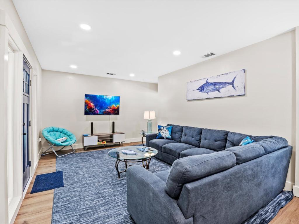 a living room with a couch and a table at Modern Coastal Cottage Near Destin & Beaches in Niceville