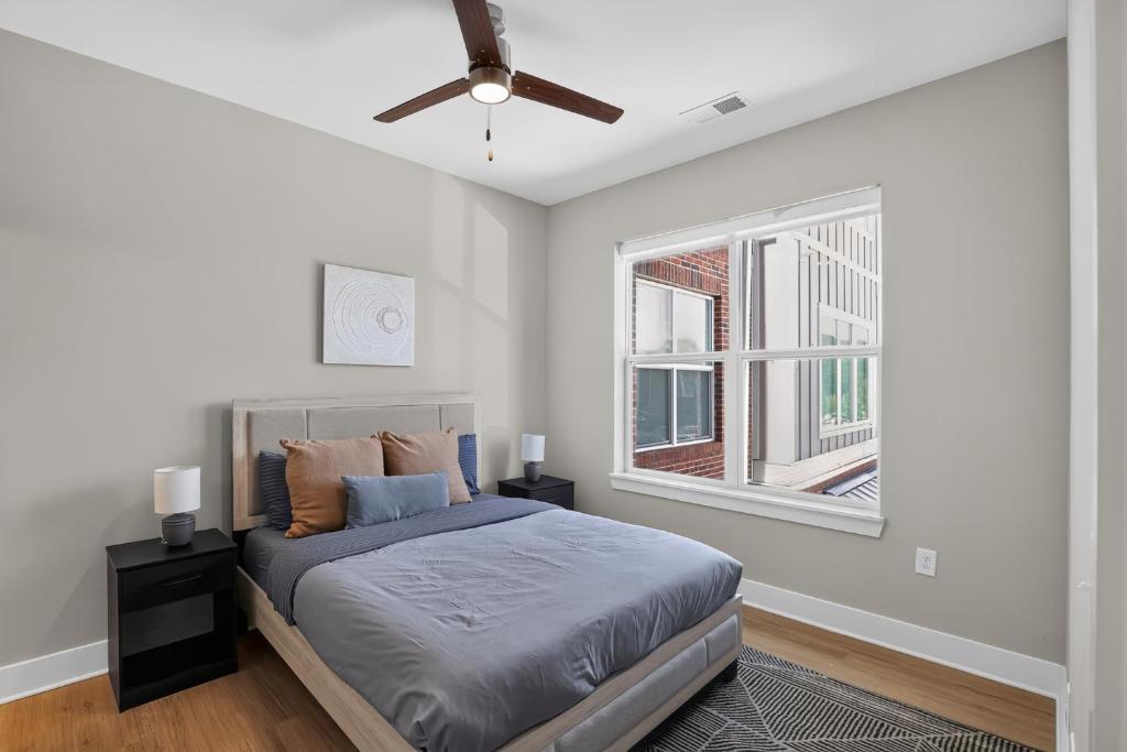 a bedroom with a bed and a ceiling fan at Parkview Greer 2BR Getaway in Greer