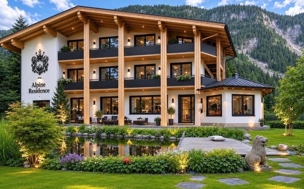 a large building with a pond in front of it at Alpine Residence by alpenappartements in Mayrhofen