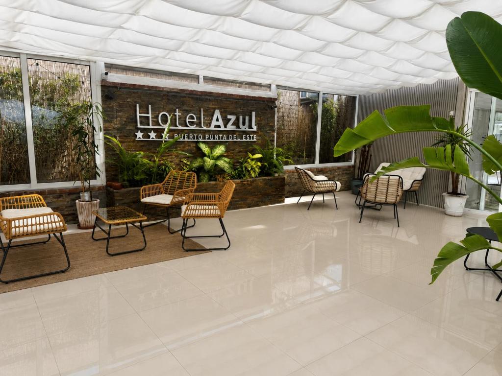 a lobby of a hotel with chairs and tables at Hotel Azul by MH in Punta del Este