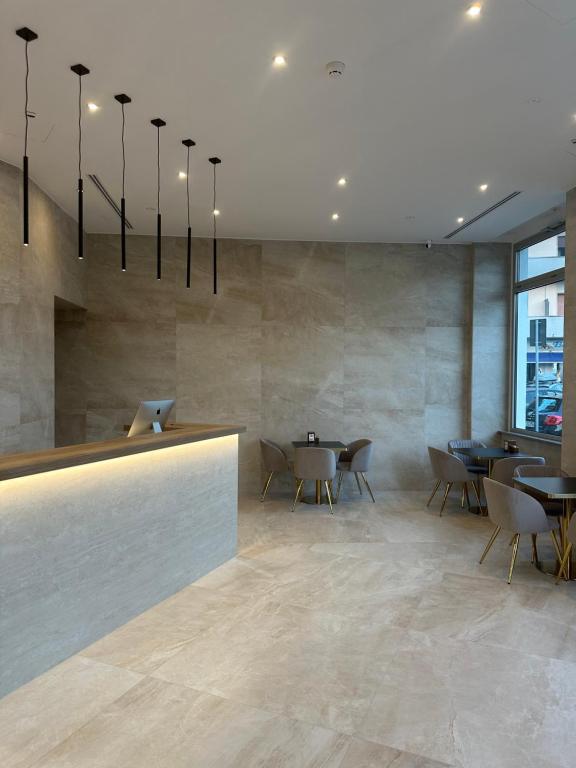 a restaurant with tables and chairs in a lobby at Hotel Corona in Termoli