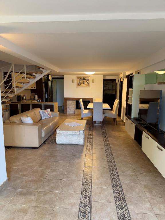 a living room with a couch and a table at Vila Srna in Petrovac na Moru