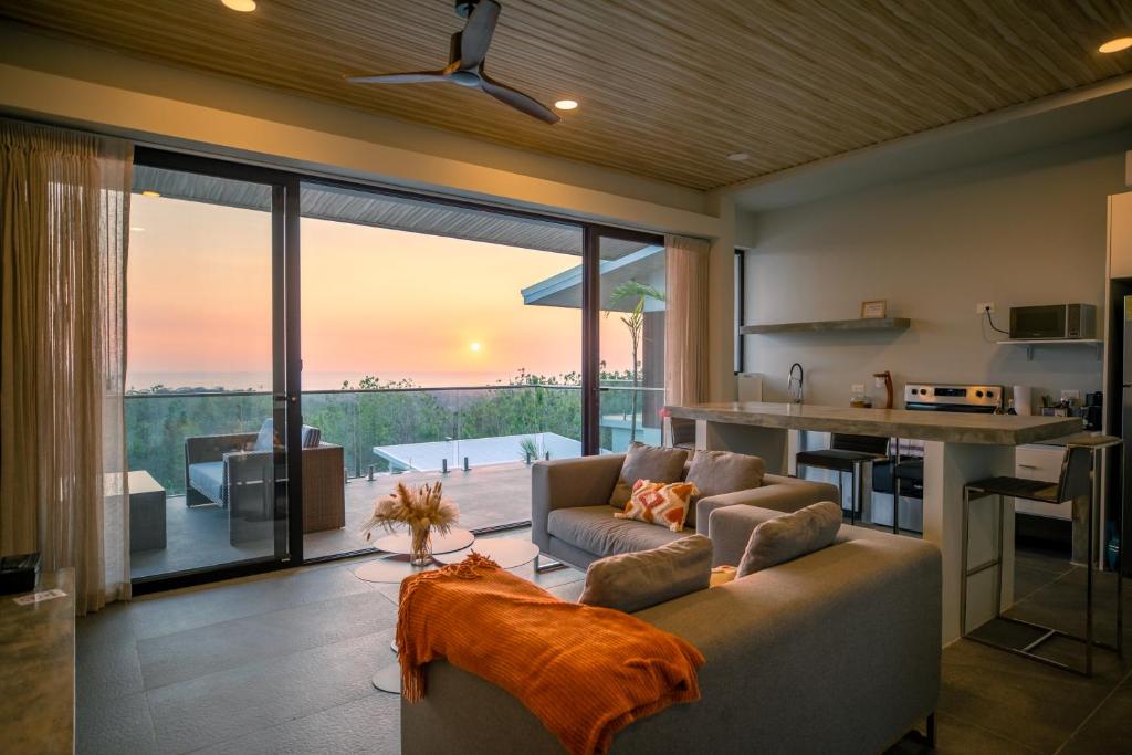a living room with a couch and a kitchen at Ocean View Villa at Solindo Stays in Marbella