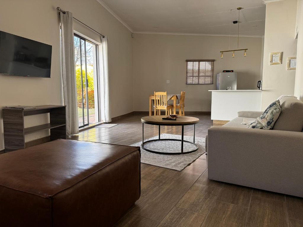 a living room with a couch and a table at Family Garden Suite - Sleeps 4 in Pretoria