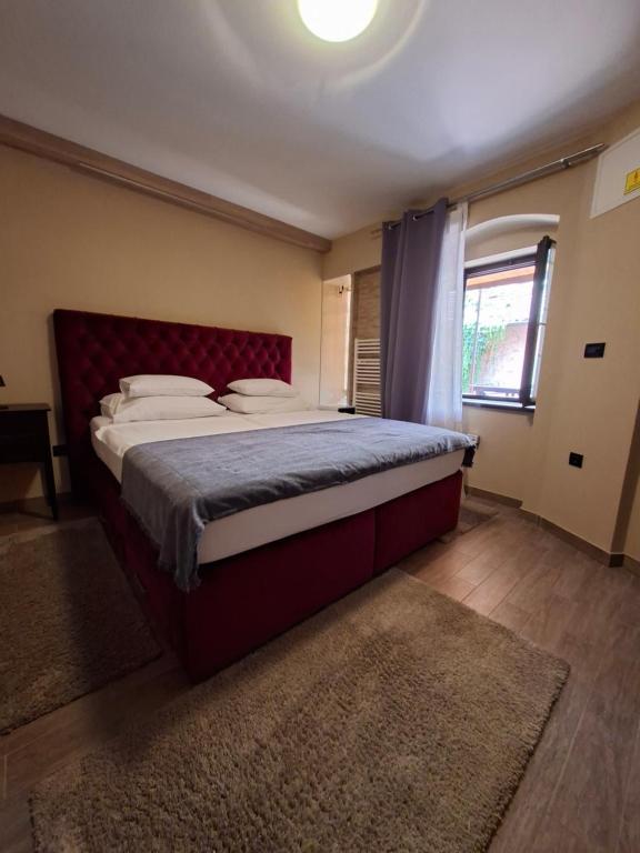 a bedroom with a large bed with a red headboard at Tkalča Room 22 in Zagreb