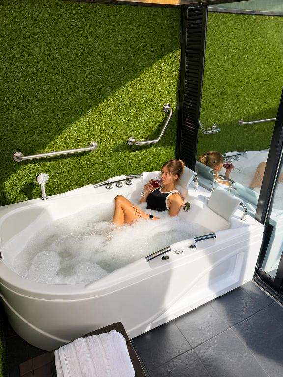 two girls are sitting in a bath tub at Laureles Premium Loft con Jacuzzi Privado in Medellín