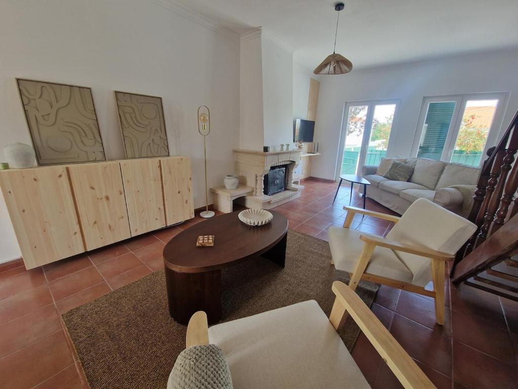 ein Wohnzimmer mit Sofa und Tisch in der Unterkunft CasaSoldoré in Sesimbra