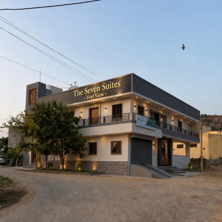 a building with a sign that reads the seven sisters first house at The Seven Suites - Fort View in Chittaurgarh