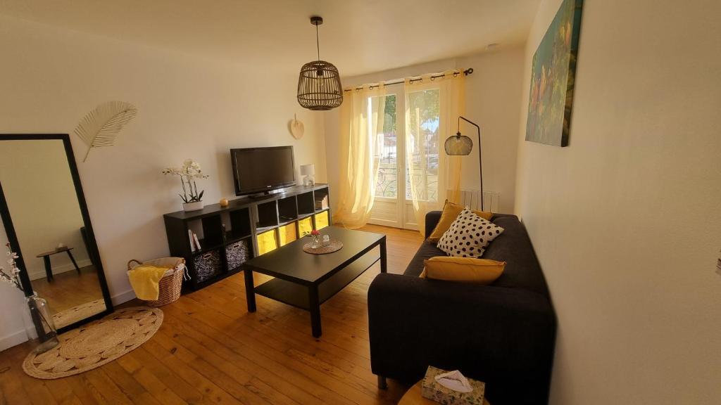 a living room with a couch and a table at Chez Gabin in Tartas