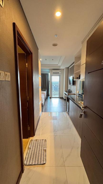 a room with a hallway with a door and a kitchen at Panbil Residence Apartment - Studio 2 Bed in Bagam