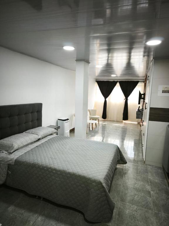 a bedroom with a large bed in a room at Apartaestudio en Cali in Cali